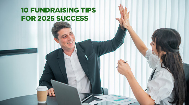 Two members of a nonprofit, sitting at a desk and high-fiving each other in congratulations.